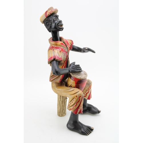 111 - A vintage hand carved figure of a Cuban Drummer. Height 43cm.