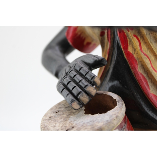 111 - A vintage hand carved figure of a Cuban Drummer. Height 43cm.