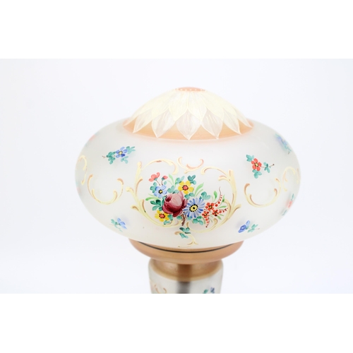 112 - A vintage glass table lamp with hand painted floral decoration. Height 34cm.