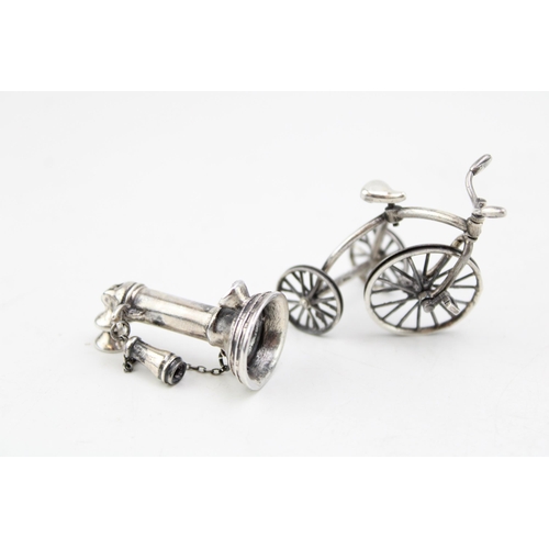 115 - Two vintage miniature silver items to include a telephone and a tricycle, made in Italy. Marked .925... 