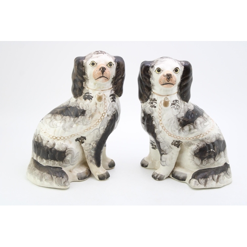 134 - A pair of ceramic Staffordshire dogs, Height 24cm.