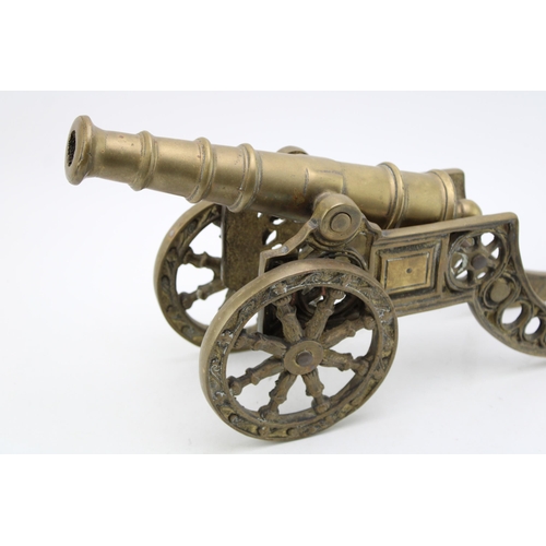 143 - A large brass model of a canon. Height 20cm, width 45cm.