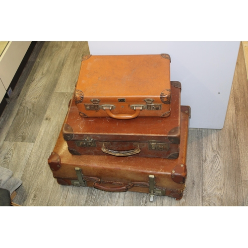 175 - A collection of three vintage trunks / suitcases in graduated sizes.