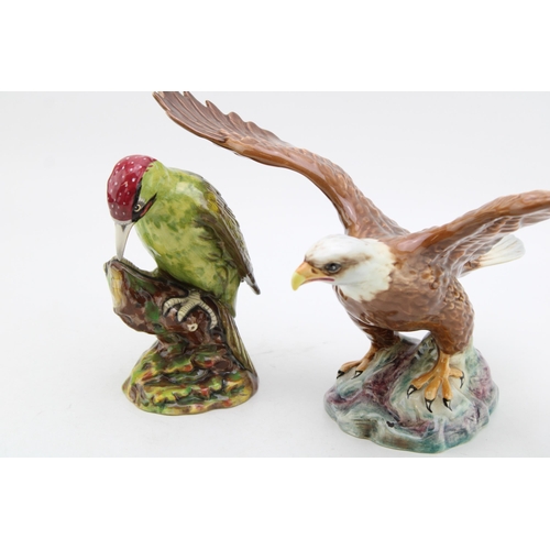 177 - A Beswick Bald Eagle together with a Royal Doulton Woodpecker. Height 19.5cm. (2)