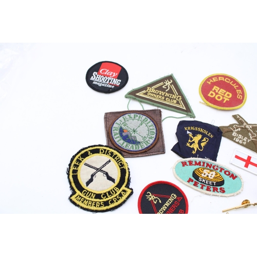 208 - A collection of vintage patches and badges relating to shooting and field sports to include 'Brownin... 