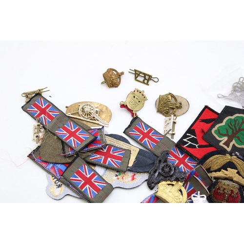 216 - A collection of patches and badges relating to the military to include Army and RAF modern and repli... 