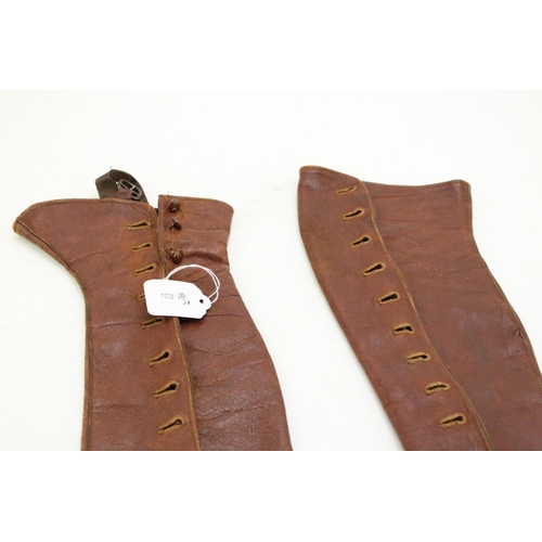 218 - A pair of antique brown leather gaiters / leggings. Length 38cm.