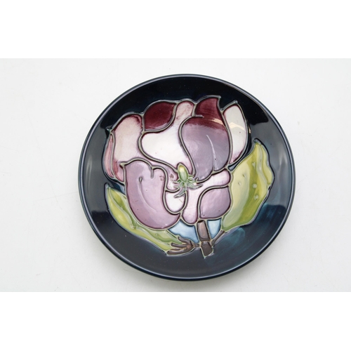 224 - A Moorcroft pin tray in the Magnolia pattern. Diameter 12cm.