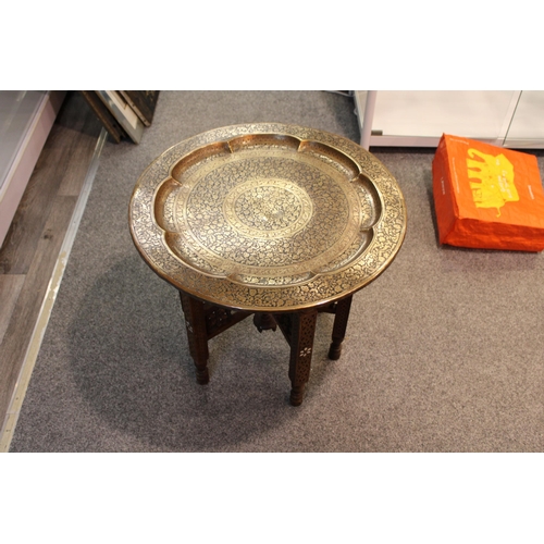 244 - A vintage middle eastern copper and brass topped occasional table with hand carved collapsible base.... 