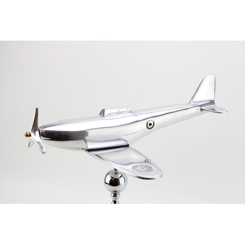 259 - A large chromed model of a Spitfire on column base. Height 35cm, width 35cm.