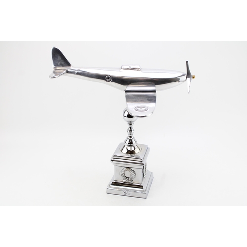 259 - A large chromed model of a Spitfire on column base. Height 35cm, width 35cm.