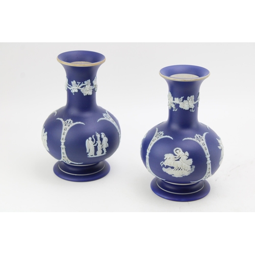 57 - A pair of Wedgwood blue dip cobalt bulbous shaped vases. Height 18cm.