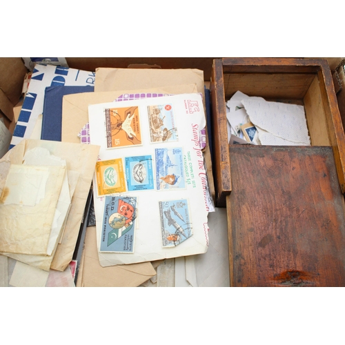 71 - A collection of vintage loose stamps and stamp albums together with a vintage wooden box. (Qty)