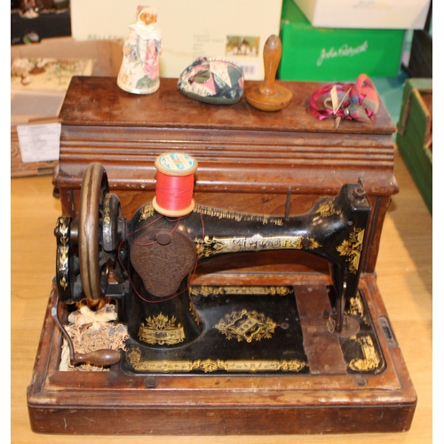 90 - A vintage 'Singer'  hand crank sewing machine complete with accessories in original case. Height 31c... 