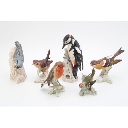 94 - A collection of Goebel birds to include 'Woodpecker', 'Nuthatch', 'Robin',  'Wren' and two other sim... 