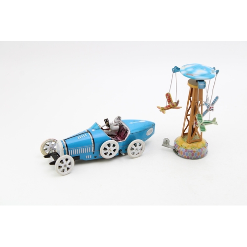 99 - Two clockwork tinplate toys to include a vintage style motorcar with driver and a tower with three a... 