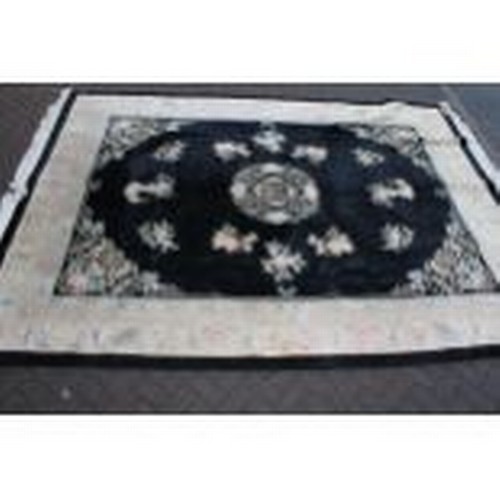 53 - A large Chinese all wool carpet in blacks and creams. 2.8m x 3.8m.