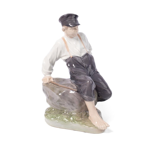 Royal Copenhagen figure of a boy with a fishing rod, no. 1659, 31cm tall.