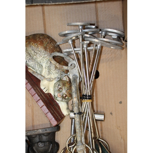 107 - A mixes collection of metalware including a cat & a golfer door stop, cattle branding irons, sewing ... 