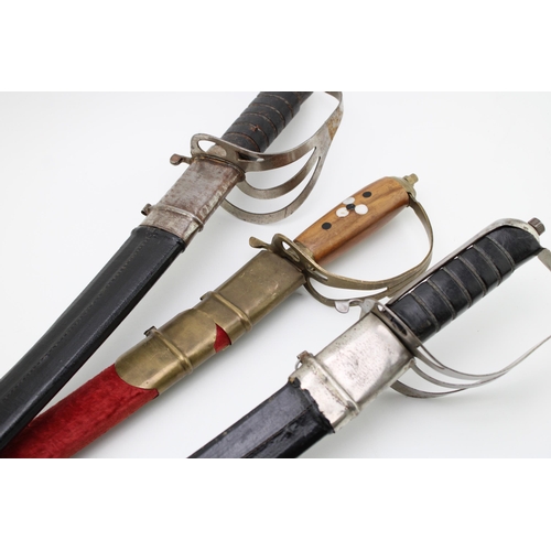 122 - Three reproduction swords in scabbards