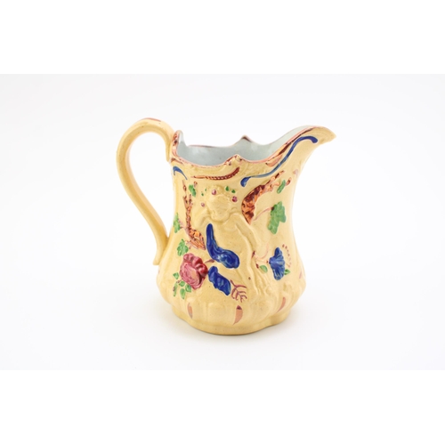 129 - Late Victorian drabware moulded jug, cherub relief, painted highlights, 11cm tall.