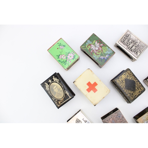 156 - A collection of matchbox holders to include cloisonné example, City of London and other similar exam... 