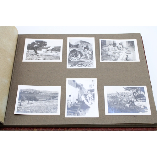 39 - A leather bound period photo album from North Africa containing an interesting collection of WWII er... 