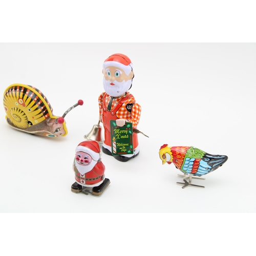 65 - A collection of clockwork tin plate toys to include Santa (2), Snail and bird. (4)