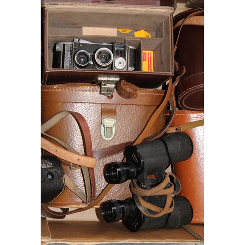 83 - A collection of binoculars and vintage camera equipment to include a pair of LIEBERMAN & GORTZ 20x40... 