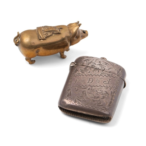 196 - A brass pig vesta case wit hinged head, sailing ship saddle and strike to the belly, together with a... 