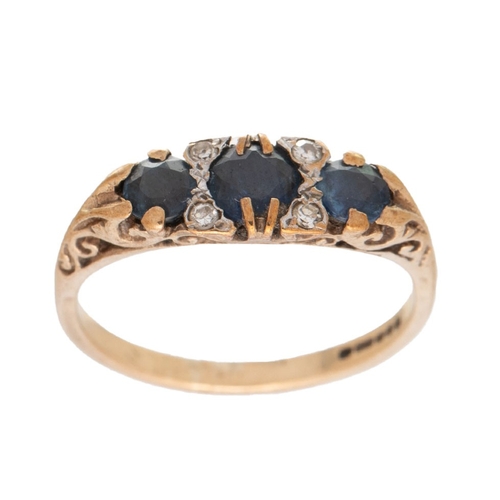 225 - A 9ct gold, sapphire and diamond three stone ring, set with three deep royal blue sapphires, the lar... 