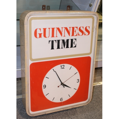 A mid century vintage 'Guinness' electric point of sale advertising clock with backlight that displays "Guiness Time", salvaged by vendor from the side of a shop, dimensions, 77cm x 56cm x 16cm.