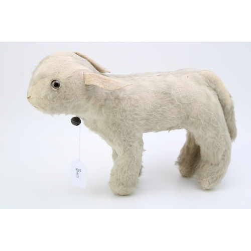 1133 - A vintage straw filled stuffed toy lamb 'Reverend', original glass c1930s. Height 25cm.