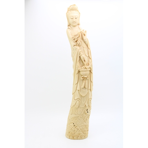 1148 - A large resin ivory style carved sculpture of a lady holding basket. Height 61cm.