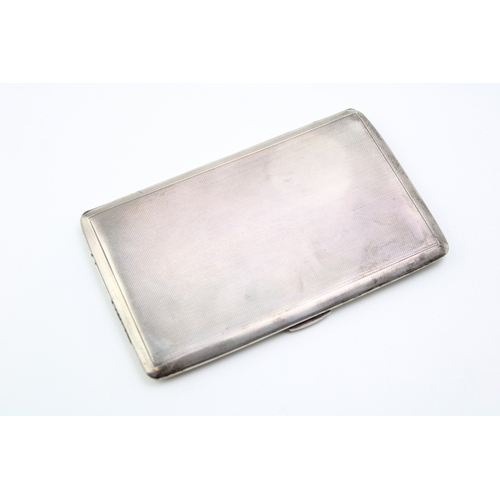 122 - A silver cigarette case with engine turned decoration, hallmarked Birmingham. Weight 211.5g.