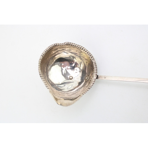 125 - A George III silver toddy ladle with baleen twist handle, the bowl with beaded rim and pouring spout... 