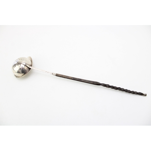 125 - A George III silver toddy ladle with baleen twist handle, the bowl with beaded rim and pouring spout... 