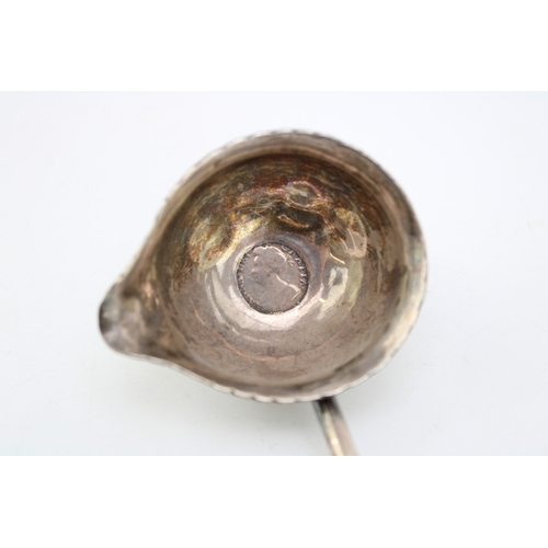 126 - A silver toddy ladle, likely 18th century though marks very rubbed, the bowl inset with a Queen Anne... 