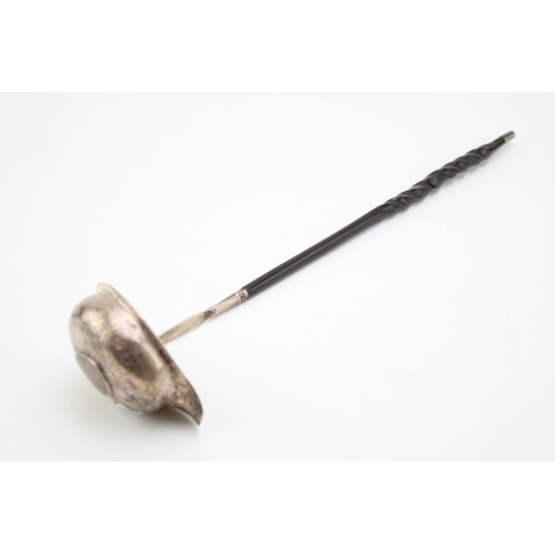 127 - A George III silver toddy ladle, the oval bowl inset with 1787 half crown, with baleen twist handle.