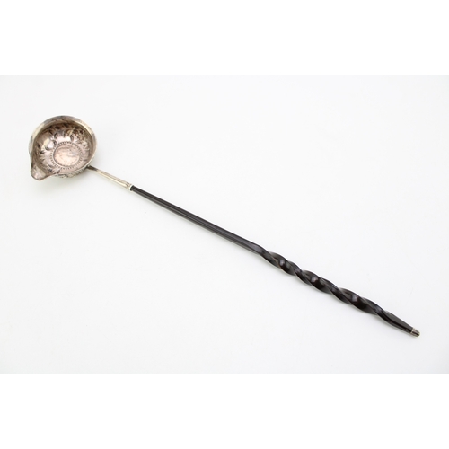 128 - A silver toddy ladle, likely 18th century with Queen Anne half crown inset, the bowl with rococo cha... 