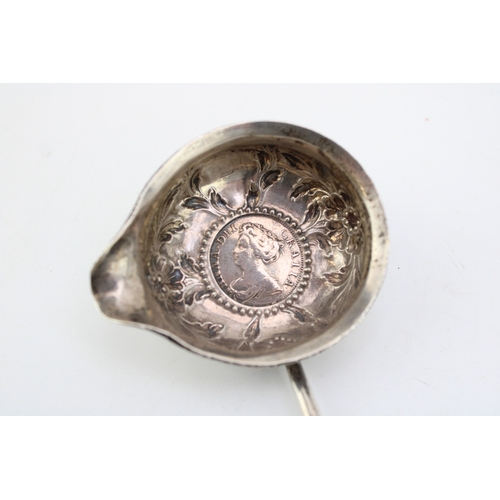 128 - A silver toddy ladle, likely 18th century with Queen Anne half crown inset, the bowl with rococo cha... 