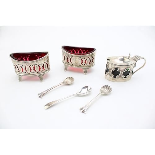 152 - A pair of silver Walker & Hall table salts with cranberry glass liners hallmarked Sheffield 1896. to... 