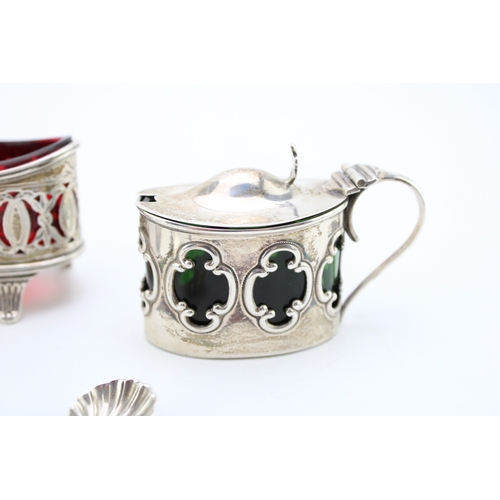 152 - A pair of silver Walker & Hall table salts with cranberry glass liners hallmarked Sheffield 1896. to... 