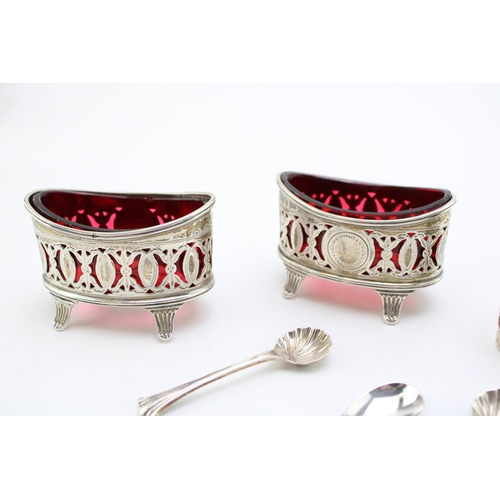 152 - A pair of silver Walker & Hall table salts with cranberry glass liners hallmarked Sheffield 1896. to... 