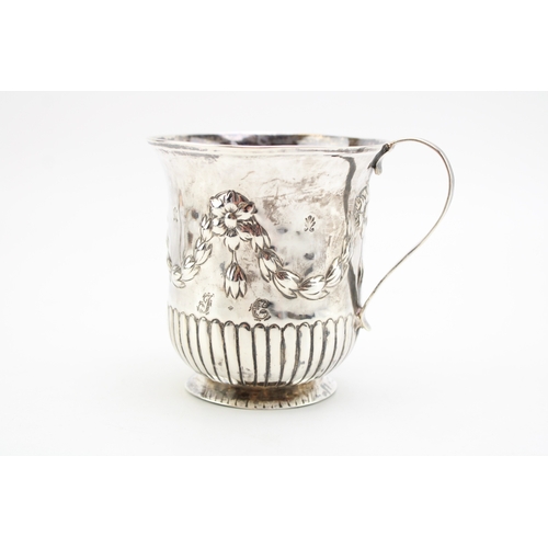 157 - A Georgian silver cup with repousse decoration, hallmarked London 1823. Weight 131g.