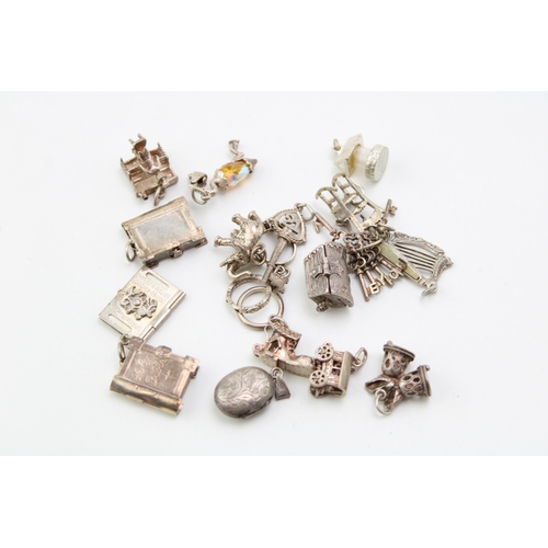 172 - A collection of silver charms for silver charm bracelets to include a treasure chest with hinged lid... 