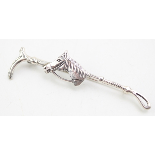 175 - Contemporary silver brooch in the form of a riding crop with horse's head, 6.5cm wide.