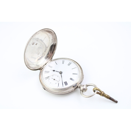 18 - Silver full hunter pocket watch, Chester 1875, winds and runs, 54mm wide.