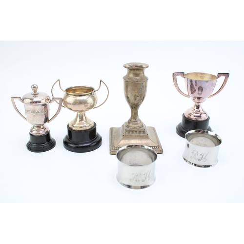 195 - Hallmarked silver candlestick, together with some small silver coloured trophies & napkin rings with... 