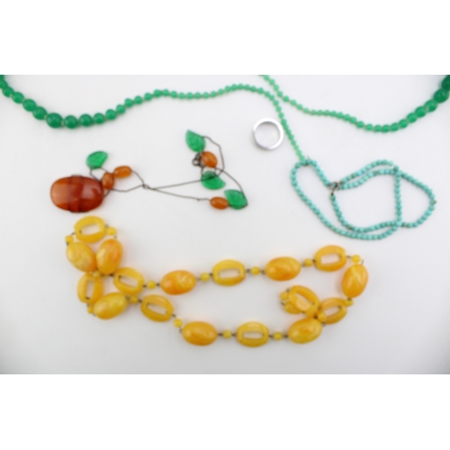 214 - A group of vintage 20th century costume jewellery comprising an amber and green glass set necklace, ... 